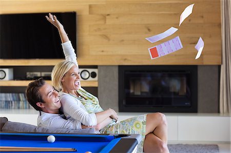 Woman tossing lottery tickets in living room Photographie de stock - Premium Libres de Droits, Code: 6113-06908732