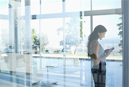 person answering phone in office - Businesswoman using cell phone in office Stock Photo - Premium Royalty-Free, Code: 6113-06908859