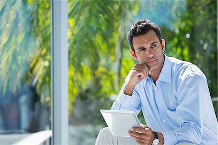 reflection, window - Businessman using tablet computer in office Stock Photo - Premium Royalty-Free, Code: 6113-06908862