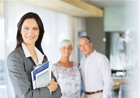 Financial advisor holding folders and tablet computer Stock Photo - Premium Royalty-Free, Code: 6113-06908812