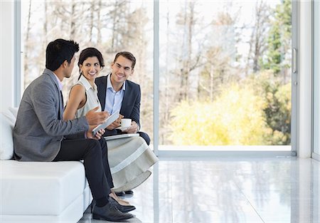 people working sitting in a row - Business people talking on sofa in office Stock Photo - Premium Royalty-Free, Code: 6113-06908957