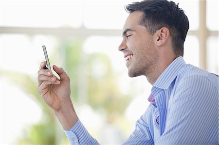 people profile - Businessman using cell phone in office Foto de stock - Sin royalties Premium, Código: 6113-06908900