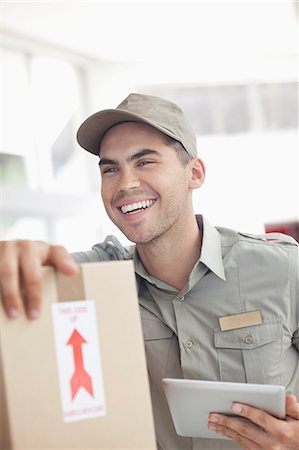 excited happy tablet - Delivery boy using tablet computer Stock Photo - Premium Royalty-Free, Code: 6113-06908921