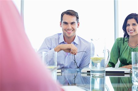 Businessman smiling in meeting Stock Photo - Premium Royalty-Free, Code: 6113-06908936