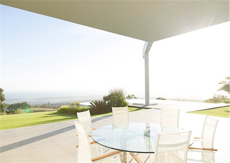 simsearch:6113-07730744,k - Table and chairs on modern porch Photographie de stock - Premium Libres de Droits, Code: 6113-06909035