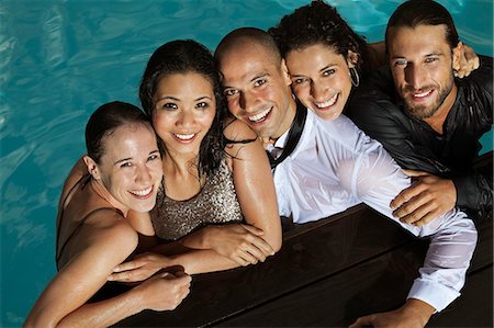 simsearch:6113-07543073,k - Fully dressed friends smiling in swimming pool Foto de stock - Sin royalties Premium, Código: 6113-06909180