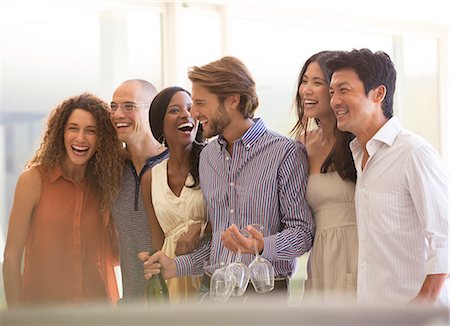 drinking white wine - Friends laughing together at party Stock Photo - Premium Royalty-Free, Code: 6113-06909102