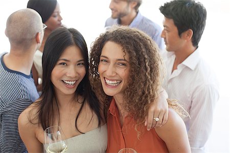 simsearch:6113-06909133,k - Women smiling together at party Stock Photo - Premium Royalty-Free, Code: 6113-06909108