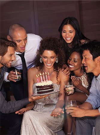 people holding candle - Friends celebrating birthday Photographie de stock - Premium Libres de Droits, Code: 6113-06909131