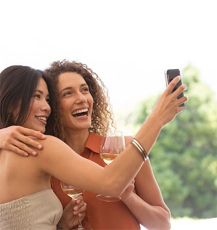 selfie drinking - Friends taking pictures together outdoors Stock Photo - Premium Royalty-Free, Code: 6113-06909247
