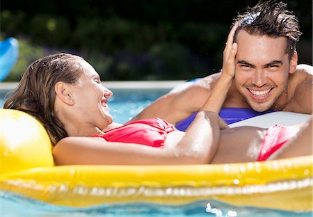 swimming pool with raft - Couple relaxing in swimming pool Stock Photo - Premium Royalty-Free, Code: 6113-06909297