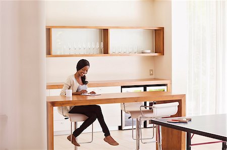 selective focus portrait not children - Woman using tablet computer at table Stock Photo - Premium Royalty-Free, Code: 6113-06909237