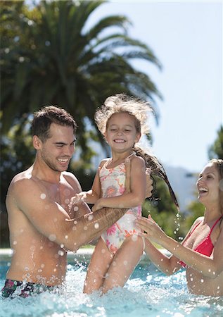 Family playing in swimming pool Stock Photo - Premium Royalty-Free, Code: 6113-06909341