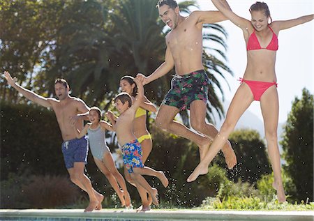 simsearch:6113-06909315,k - Family jumping into swimming pool Stock Photo - Premium Royalty-Free, Code: 6113-06909379