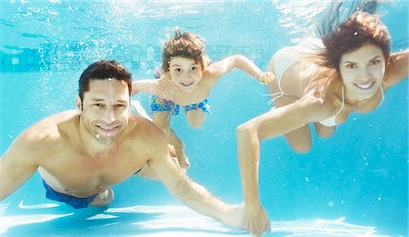 swimming - Family swimming in pool Stock Photo - Premium Royalty-Free, Code: 6113-06909303