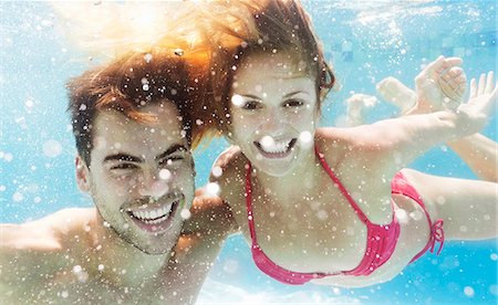 Couple swimming in pool Stock Photo - Premium Royalty-Free, Code: 6113-06909333