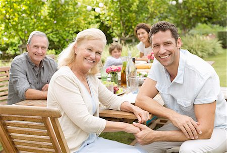 family outside picnic - Mother and son smiling in backyard Stock Photo - Premium Royalty-Free, Code: 6113-06909449