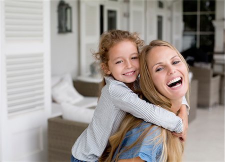 Mother and daughter playing on porch Stock Photo - Premium Royalty-Free, Code: 6113-06909450