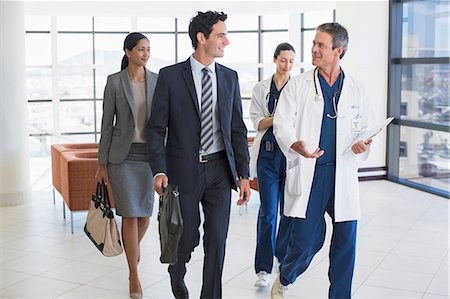 Doctors and business people talking in hospital Stock Photo - Premium Royalty-Free, Code: 6113-07146740