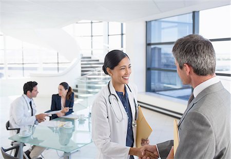 simsearch:6113-06498829,k - Doctor and businessman handshaking in meeting Stock Photo - Premium Royalty-Free, Code: 6113-07146761