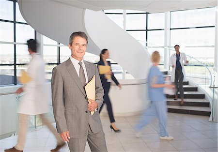 physician businessman - Portrait of smiling businessman in hospital Stock Photo - Premium Royalty-Free, Code: 6113-07146766