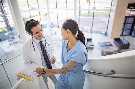 doctor and nurse man - Doctor and nurse talking on staircase in hospital Stock Photo - Premium Royalty-Free, Code: 6113-07146776