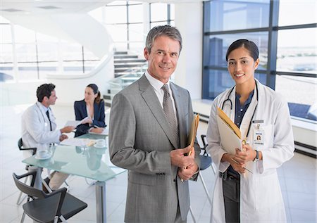 expert - Portrait of smiling businessman and doctor in meeting Stock Photo - Premium Royalty-Free, Code: 6113-07146797