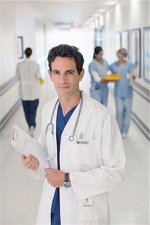 doctor in hallway - Portrait of smiling doctor in hospital Stock Photo - Premium Royalty-Free, Code: 6113-07146710