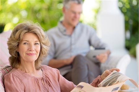 senior couple close up - Senior woman reading newspaper on patio Stock Photo - Premium Royalty-Free, Code: 6113-07146843