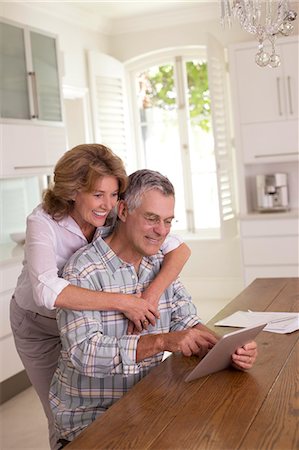 simsearch:6113-09157606,k - Senior couple using digital tablet in kitchen Stock Photo - Premium Royalty-Free, Code: 6113-07146853