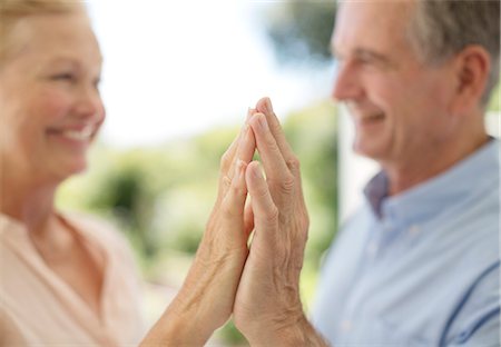 Senior couple touching hands on patio Stock Photo - Premium Royalty-Free, Code: 6113-07146871