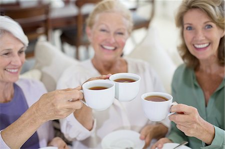 Senior women toasting coffee cups Stock Photo - Premium Royalty-Free, Code: 6113-07146881