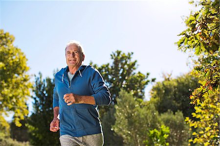 Senior man running in park Stock Photo - Premium Royalty-Free, Code: 6113-07146892
