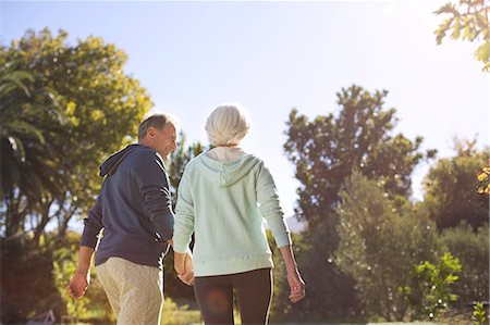 simsearch:649-03881964,k - Senior couple holding hands and walking in park Stock Photo - Premium Royalty-Free, Code: 6113-07146898