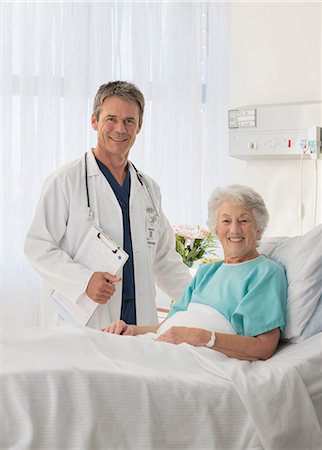 Portrait of smiling doctor and senior patient in hospital room Stock Photo - Premium Royalty-Free, Code: 6113-07146817