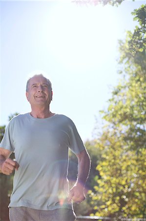 Senior man running outdoors Stock Photo - Premium Royalty-Free, Code: 6113-07146825