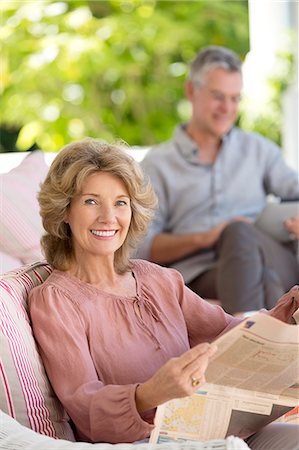 senior couple eye contact head and shoulders not indoors - Portrait of senior woman reading newspaper on patio Stock Photo - Premium Royalty-Free, Code: 6113-07146942