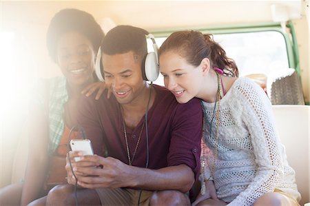 simsearch:6113-07961655,k - Friends listening to mp3 player in camper van Stock Photo - Premium Royalty-Free, Code: 6113-07146959