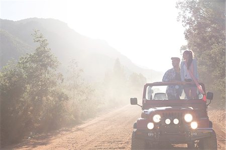 driving dirt - Friends driving sport utility vehicle on dirt road Stock Photo - Premium Royalty-Free, Code: 6113-07146961