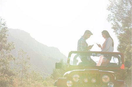 Couple using cell phones in sport utility vehicle Stock Photo - Premium Royalty-Free, Code: 6113-07146969