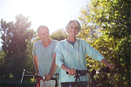 simsearch:6113-06499065,k - Senior couple walking bicycles in park Stock Photo - Premium Royalty-Free, Code: 6113-07146904