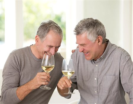 simsearch:6113-07146829,k - Senior men laughing and drinking white wine Foto de stock - Sin royalties Premium, Código: 6113-07146905