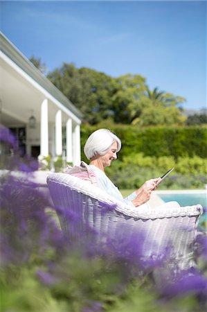 seniors relaxing outdoor copy space - Senior woman using digital tablet in garden Stock Photo - Premium Royalty-Free, Code: 6113-07146926