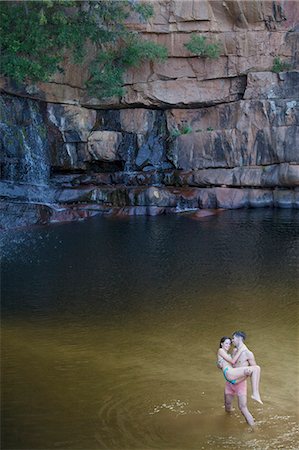 pond top view - Man carrying girlfriend in pool Stock Photo - Premium Royalty-Free, Code: 6113-07147042