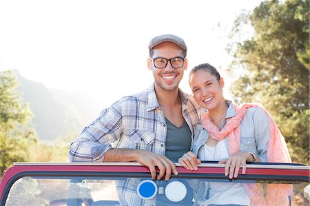 photo travel pose - Portrait of smiling couple in sport utility vehicle Stock Photo - Premium Royalty-Free, Code: 6113-07147050