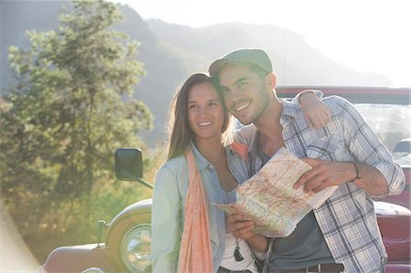 simsearch:6113-07147043,k - Smiling couple with map next to sport utility vehicle Stock Photo - Premium Royalty-Free, Code: 6113-07147054
