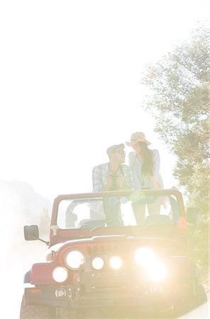 roadtrip vacation - Couple standing in sport utility vehicle Stock Photo - Premium Royalty-Free, Code: 6113-07147066