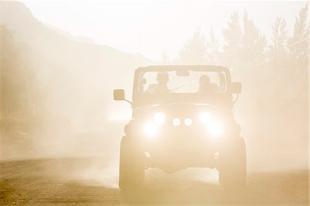 Sport utility vehicle driving on dirt road Stock Photo - Premium Royalty-Free, Code: 6113-07147078