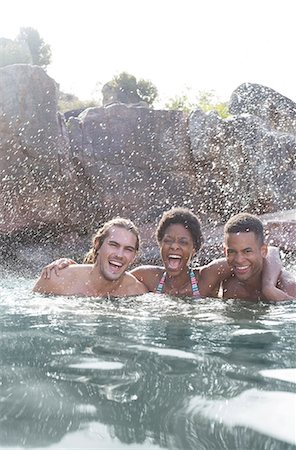 Friends laughing in river Stock Photo - Premium Royalty-Free, Code: 6113-07147085