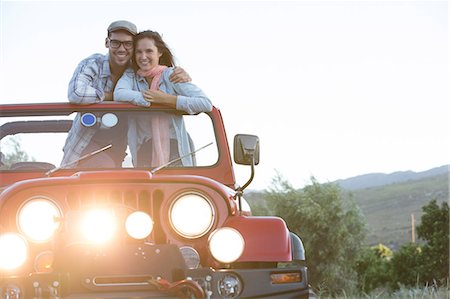 Couple hugging in sport utility vehicle Stock Photo - Premium Royalty-Free, Code: 6113-07147035